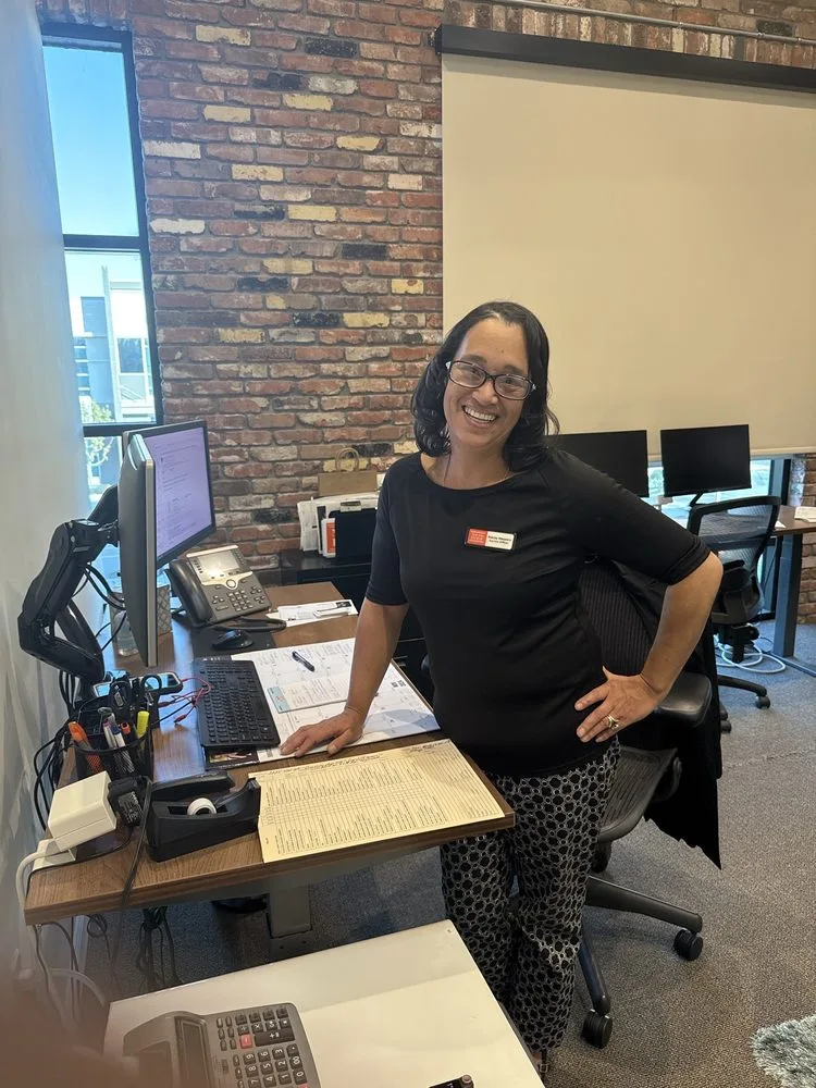 A New Era Escrow team member at her desk